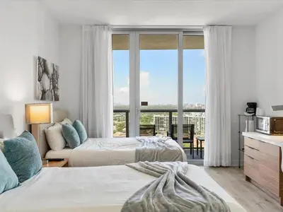 a bedroom with two beds and a large window at Near Aventura Mall 2B 2B with beach and pool 2403 in Hallandale Beach