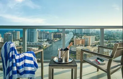 a bottle of wine on a table on a balcony at Near Aventura Mall 2B 2B with beach and pool 2403 in Hallandale Beach