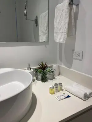 a white bathroom with a sink and a mirror at Suite with Beach Serv Pool and close to Aventura Mall 2808 in Hallandale Beach