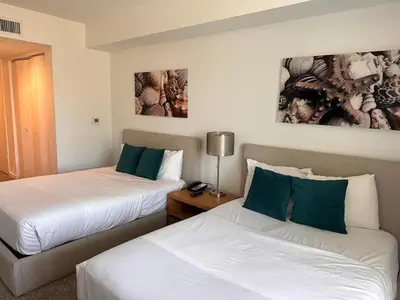a hotel room with two beds and a lamp at 2b 1b Hallandale Beach Studio with heated Pool 2610 in Hallandale Beach