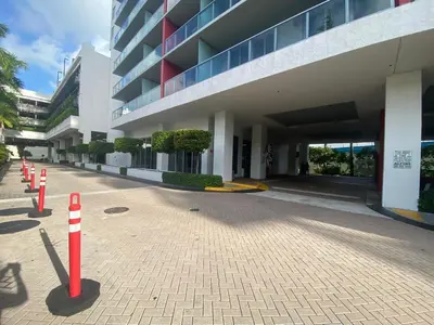 a building with red and white cones in front of it at Miami Beautiful with kitchen, pool and mall Apmt 1B 1B 1408 in Hallandale Beach