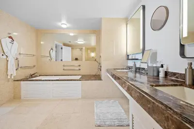 a bathroom with a sink and a large mirror at Oceanfront Ritz-Carlton 1 Bedroom Luxury Residence in Fort Lauderdale