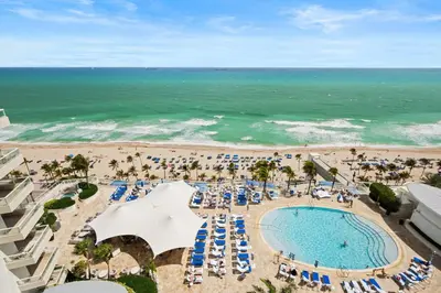 an aerial view of a pool and the beach at Oceanfront Ritz-Carlton 1 Bedroom Luxury Residence in Fort Lauderdale