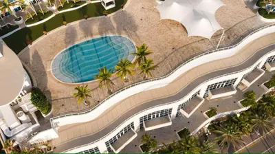 an overhead view of a swimming pool at a resort at Oceanfront Ritz-Carlton 1 Bedroom Luxury Residence in Fort Lauderdale