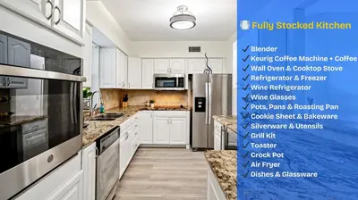 a kitchen with white cabinets and a blue wall at Sleeps 12 Private Pool & Gameroom near Casino, Beaches & Hard Rock Stadium in Hollywood