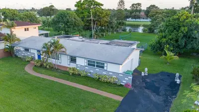 an aerial view of a house with a yard at Renovated Sept 2024! Pool - Mini Golf - Volleyball in Joe Robbie Stadium Heliport