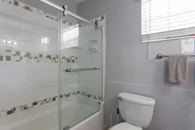 a bathroom with a shower and a toilet and a tub at Renovated Sept 2024! Pool - Mini Golf - Volleyball in Joe Robbie Stadium Heliport