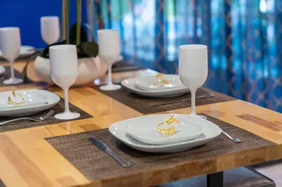 a table with plates and glasses on a wooden table at Renovated Sept 2024! Pool - Mini Golf - Volleyball in Joe Robbie Stadium Heliport