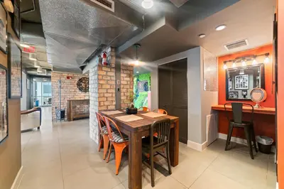 a dining room with a wooden table and chairs at Hollywood Beach Speakeasy Condo in Hollywood