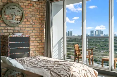 a bedroom with a bed and a large window at Hollywood Beach Speakeasy Condo in Hollywood