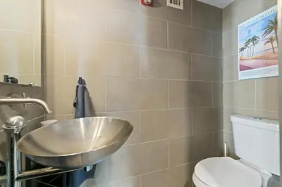 a bathroom with a sink and a toilet at Hollywood Beach Speakeasy Condo in Hollywood