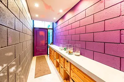 a room with a pink brick wall and a purple door at Piano House on the Water in Fort Lauderdale