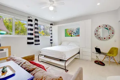 a bedroom with a bed and a couch at Studio in Las Olas near FL Beach in Fort Lauderdale
