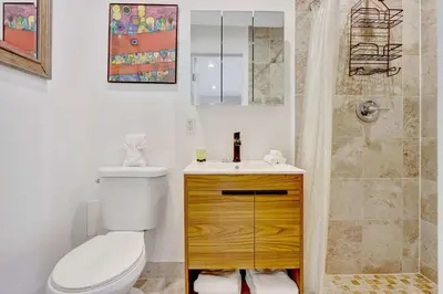 a bathroom with a toilet and a sink and a shower at Studio in Las Olas near FL Beach in Fort Lauderdale