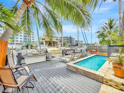 a deck with chairs and a swimming pool at Studio in Las Olas near FL Beach in Fort Lauderdale