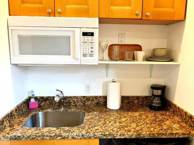 a kitchen counter with a sink and a microwave at Studio in Las Olas near FL Beach in Fort Lauderdale