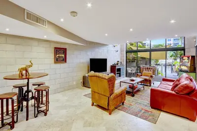 a living room with a couch and a table at Singer House on the Water in Fort Lauderdale