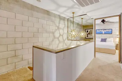 a bedroom with a bed and a mirror at Singer House on the Water in Fort Lauderdale