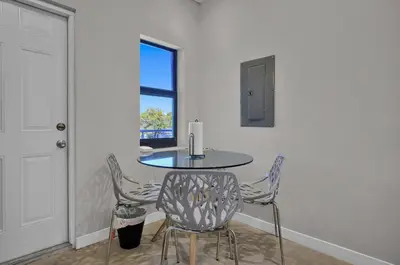 a table and chairs in a room with a window at Miami Flats - Self Check-in and 1 Free Parking in Miami