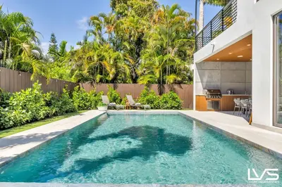 a swimming pool in the backyard of a house at Villa Enclave- Brand New Luxe Las Olas Beach Villa in Fort Lauderdale