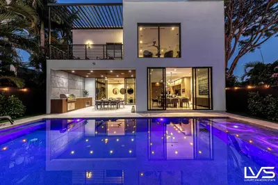 a house with a swimming pool in front of a house at Villa Enclave- Brand New Luxe Las Olas Beach Villa in Fort Lauderdale