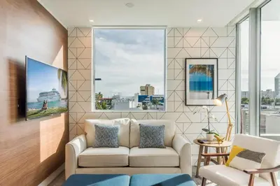 a living room with a couch and a large window at 2BR Modernos South Beach | 5 min da praia in Miami Beach