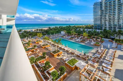 an aerial view of a resort with a pool and the ocean at 2 Bedroom Private Residence at Roney Palace -6072B in Miami Beach