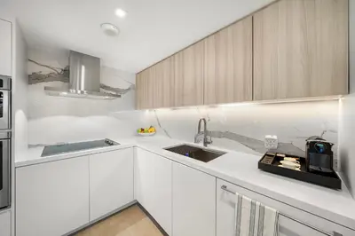 a kitchen with white cabinets and a sink at 2 Bedroom Private Residence at Roney Palace -6072B in Miami Beach