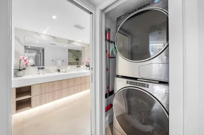 a washer and dryer in a bathroom with a mirror at 2 Bedroom Private Residence at Roney Palace -6072B in Miami Beach