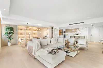 a living room with a white couch and a table at 1 Bedroom Plus Den Private Residence at Roney Palace -608 in Miami Beach
