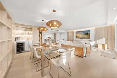 a dining room and living room with a table and chairs at 5 Bedrooms Private Residence at Roney Palace -6078 in Miami Beach