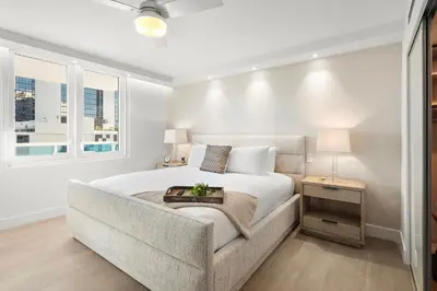 a white bedroom with a bed and a chair at 5 Bedrooms Private Residence at Roney Palace -6078 in Miami Beach