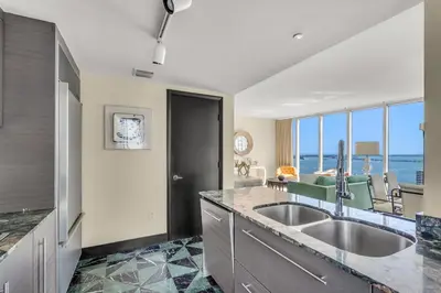 a kitchen with a sink and a view of the ocean at Stunning Apartment at Icon with Bay Views-Pool-Gym-Spa in Miami