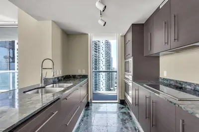 a kitchen with a sink and a large window at Stunning Apartment at Icon with Bay Views-Pool-Gym-Spa in Miami