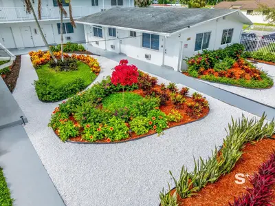 a garden in front of a house with flowers at Modern Studio - Gym & Parking Close to Aventura in Miami