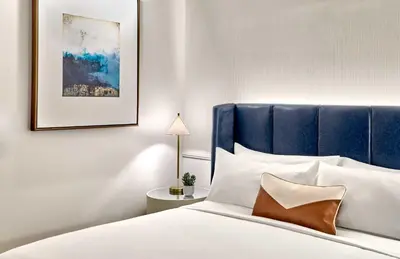 a bedroom with a bed with a blue headboard at Omni Fort Lauderdale Hotel in Fort Lauderdale