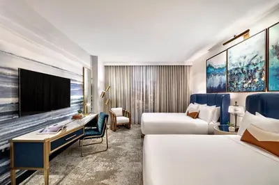 a hotel room with two beds and a desk at Omni Fort Lauderdale Hotel in Fort Lauderdale