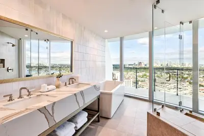 a bathroom with two sinks and a large mirror at Omni Fort Lauderdale Hotel in Fort Lauderdale