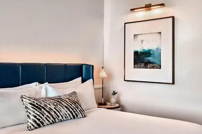 a bedroom with a bed with a blue headboard at Omni Fort Lauderdale Hotel in Fort Lauderdale