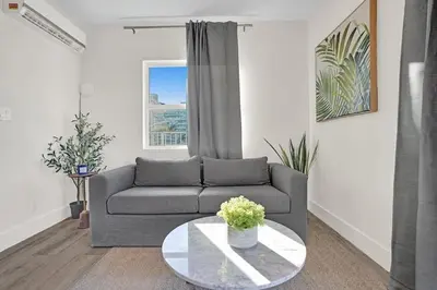 a living room with a couch and a table at Penthouse EDEN 2BR with ocean view in Fort Lauderdale