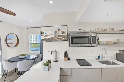 a kitchen with a sink and a microwave on the wall at Penthouse EDEN 2BR with ocean view in Fort Lauderdale