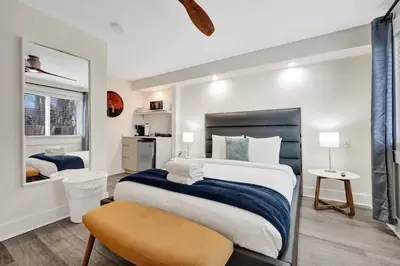 a bedroom with a large bed and a mirror at NEW Studio at Eden Collection Steps to Beach 1106 in Fort Lauderdale