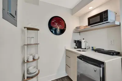 a small kitchen with a sink and a microwave at NEW Studio at Eden Collection Steps to Beach 1106 in Fort Lauderdale