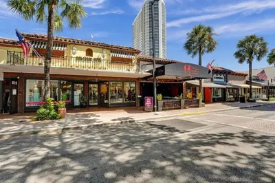 a street in a town with palm trees and a building at Eden Collection Studio Steps to Beach in Fort Lauderdale