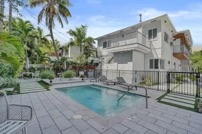 a swimming pool in front of a house at 2102 Eden Collection 1BR Kitchen Steps to beach in Fort Lauderdale