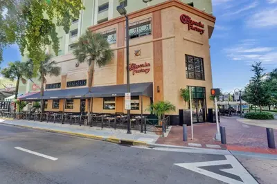 a building on the corner of a street with a restaurant at Eden Escape Walk to FLT Beach 1104 in Fort Lauderdale