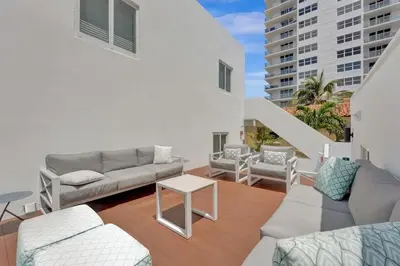 a living room with a couch and a table at Eden Escape Walk to FLT Beach 1103 in Fort Lauderdale