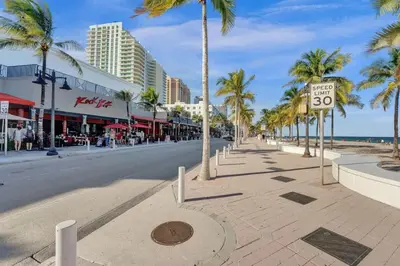 a city street with palm trees and a speed limit sign at Eden Escape Walk to FLT Beach 1103 in Fort Lauderdale