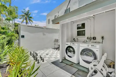 a house with a washer and dryer in a yard at Eden Escape Walk to FLT Beach 1103 in Fort Lauderdale