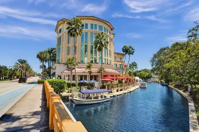 a hotel with boats in a canal in front of a building at Eden Escape Walk to FLT Beach 1201 in Fort Lauderdale